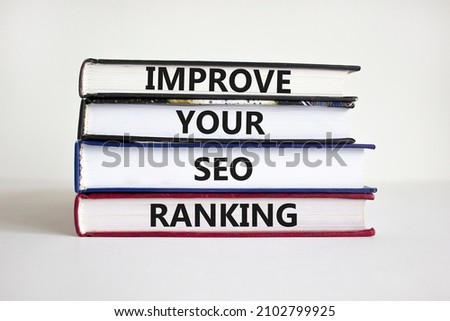Improve SEO ranking symbol. Concept words 'Improve your SEO ranking' on books on a beautiful white background. Businessman hand. Business, Improve your SEO ranking concept. Royalty-Free Stock Photo #2102799925
