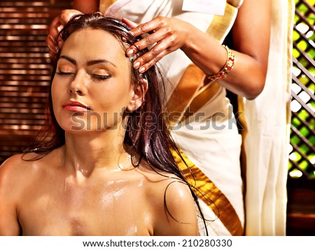 Young woman having head ayurveda spa treatment.