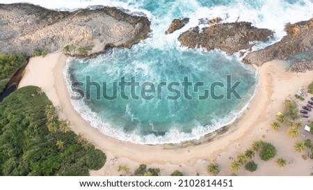 A beautiful aerial top-down picture of a beach with a form of a shell on a sunny day - Mar Chiquita