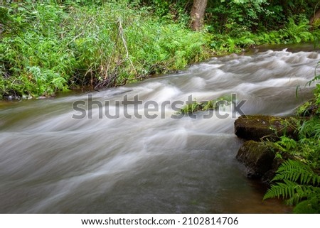 Rapidly flowing river. Long exposure photo.