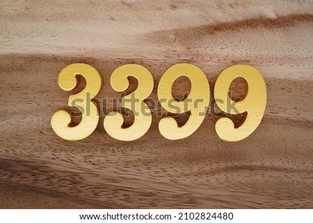 Golden Arabic numerals 3399 on a dark brown to white wood grain background.
