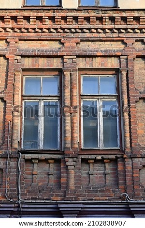 a fragment of an intricate red brick facade