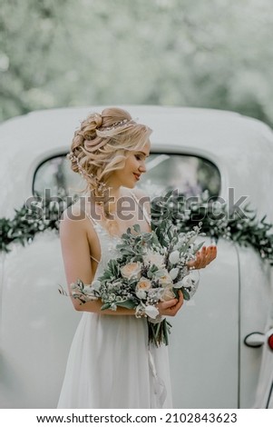 Beautiful bride next to the retro car. Royalty-Free Stock Photo #2102843623
