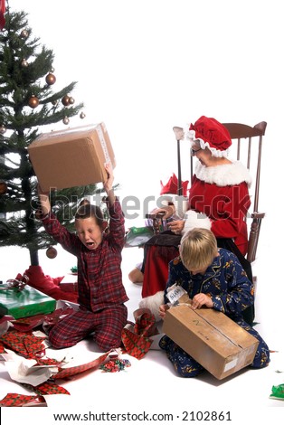 A bratty child having a tantrum under the Christmas tree while his brother and Mrs. Santa look on