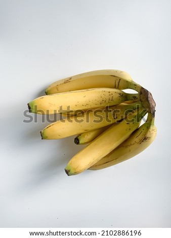 Banana on white background, with some shadow and selective focus.