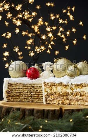 A slice of a cake on a background of christmas lights