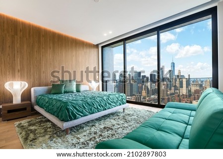Modern and contemporary bedroom in Brooklyn, New York with views of upper Manhattan. Condo or Hotel accommodation. Sage Green and maple colors. Royalty-Free Stock Photo #2102897803