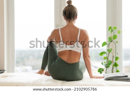 Young woman relaxing after physical therapy or massage session Royalty-Free Stock Photo #2102905786