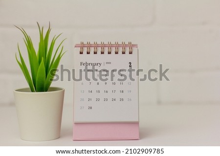 Desktop calendar for February 2022 on a light background