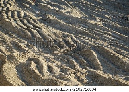 Footprints on the sand of the bulldozer tracks, imprinted for beach nourishment after repeated storm surges.
