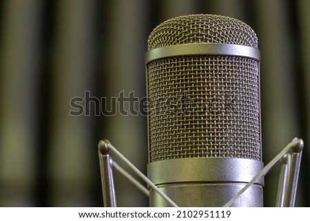 Condenser studio microphone in a Catholic church against the background of organ pipes. Recording of a concert of organ music. Professional sound recording.