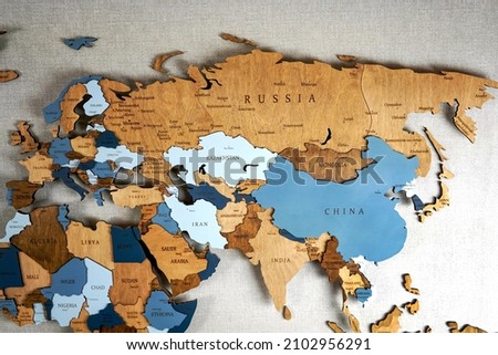 Continent Eurasia on the political map. Wooden world map on the wall.  Royalty-Free Stock Photo #2102956291