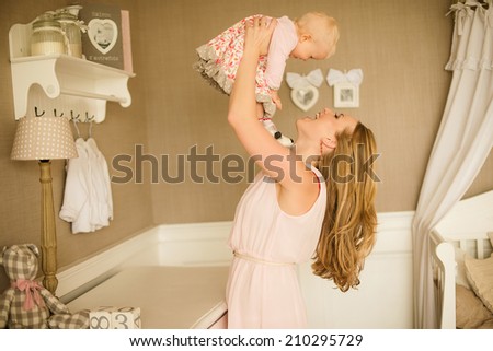 happy family. Mother throws up and kissing baby