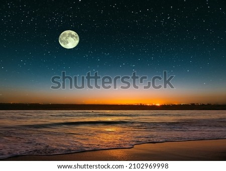 full moon on blue night  starry sky on pink yellow sunset at sea skyline  nebula nature background 