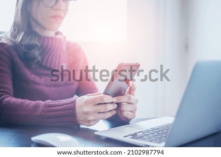 A businesswoman hand working digital marketing media in virtual screen with mobile phone and modern compute in office