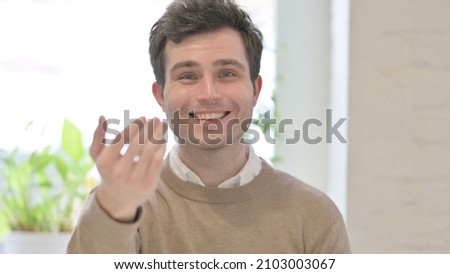 Portrait of Man Pointing at the Camera and Inviting