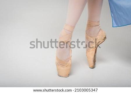 feet in pointe shoes. Legs of a young female ballerina on a white background. Art, movement, inspiration concept. Classical ballerina in pointe shoes