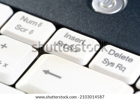 Printscreen key, print screen button, screen capture key on a laptop computer keyboard, object macro extreme closeup Making a screencap screenshotting, saving a digital display image, picture concept