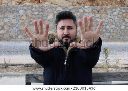 Handsome bearded man showing hands. Male hand reaching out 