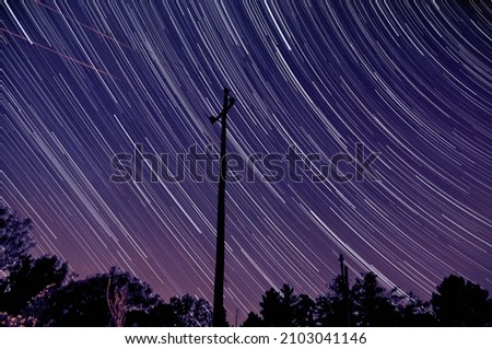 startrail with powerpole with violet sky