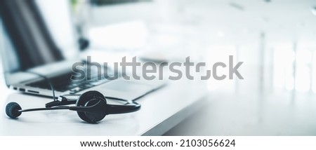 Headset and customer support equipment at call center ready for actively service . Corporate business help desk and telephone assistance concept . Royalty-Free Stock Photo #2103056624