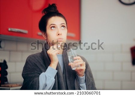 
Woman Having a Cold Taking anti-viral Drug Treatment. Sick person feeling unwell deciding if to take pills or not 
 Royalty-Free Stock Photo #2103060701