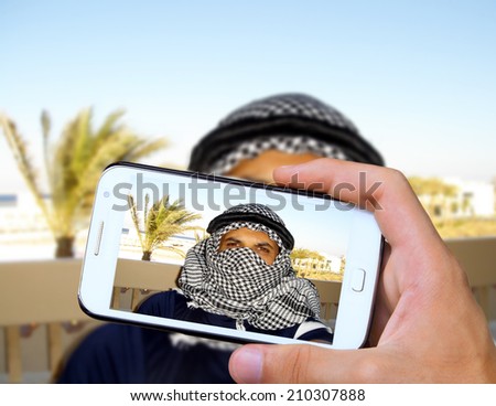 Hands taking photo arabic man with smartphone 