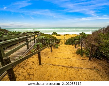 View of a clean and quiet beach with clear sky, no people. Entrance to the Ninety Mile Beach in Victoria, Australia. Royalty-Free Stock Photo #2103088112