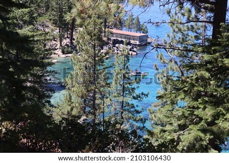 Lake tahoe with boats and woodlands. Many green trees