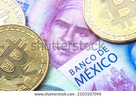 Calgary, Alberta, Canada. Jan 8, 2022. Mexican currency with bitcoins