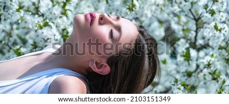 Beauty girl feeling spring. Spring sunny day. Beauty young woman enjoying nature in spring garden. Banner spring design, advertising for website header. Royalty-Free Stock Photo #2103151349