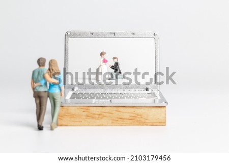 Miniature people Bride and groom virtual wedding on computer screen, Happy Valentines Day concept
