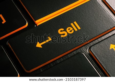 Shopping concept, Close-up laptop keyboard with orange light button Sell
