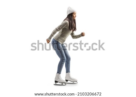 Full length profile shot of a young casual woman ice skating isolated on white background