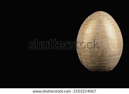 Easter gold egg. Big egg on black background.