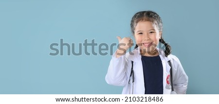Happy little girl  in doctor coat with stethoscope. Child playing. Future occupation or dream job concept. Happy children's day.