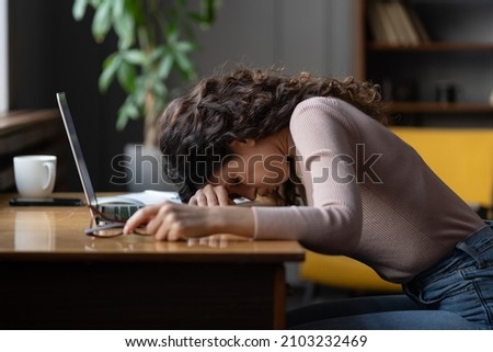 Work burnout. Tired exhausted female employee feeling energy depletion or exhaustion, overworked stressed female putting head down on table, suffering from chronic job stress. Overwork concept Royalty-Free Stock Photo #2103232469