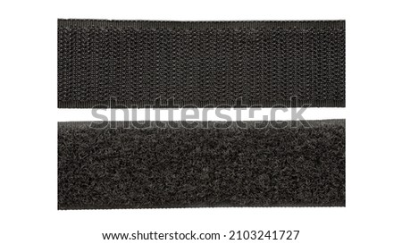 Contact tape isolated on white background, top view. Black velcro on a white background. Velcro fastener for clothes isolated on white background, top view. Black velcro, top view. Royalty-Free Stock Photo #2103241727