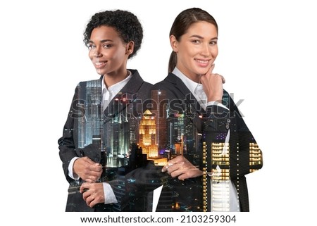 Two attractive businesswomen in suits, hand on chin. Asia corporate lifestyle, multinational diverse young professionals. Night Kuala Lumpur city view. Double exposure