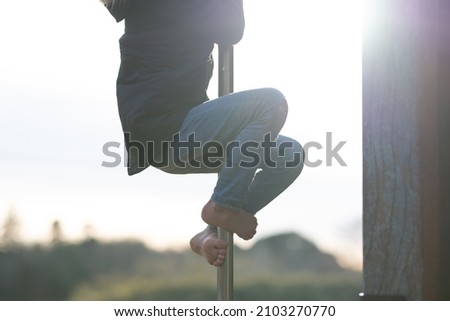 A child climbing a climbing pole