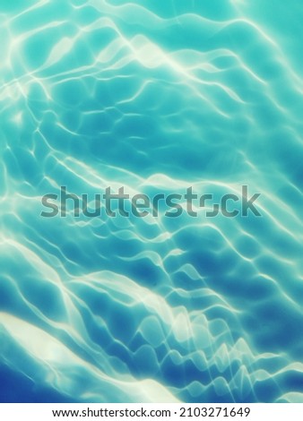 Blur​ abstract​ of​ surface​ blue​ water. Abstract​ of​ surface​ blue​ water​ reflected​ with​ sunlight​ for​ background. Blue​ sea or Blue​ water pattern​ for​ background.