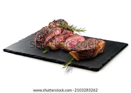 Fiorentina T-bone steak on Rectangular plate in black slate isolated on white background Royalty-Free Stock Photo #2103283262