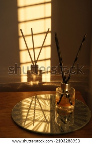 Modern and contemporary light reflections on shadows atmospheric and moody. Simple, minimalist elegant and sophisticated classic noir style interior design. Copper or bronze colour highlights Royalty-Free Stock Photo #2103288953