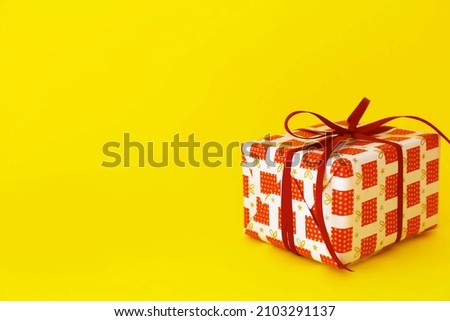 gift with red ribbon in the yellow background