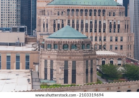 an art deco style stone building in the city of chicago illnois seen from above. 