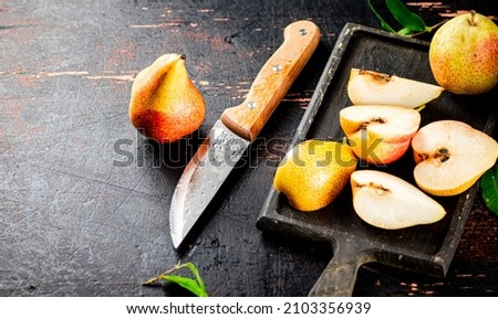 Sliced fresh pear on a cutting board. Against a dark background. High quality photo