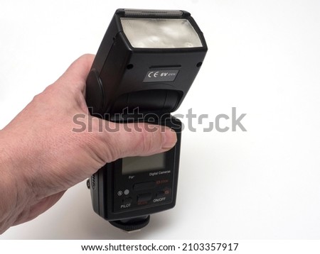photo flash in hand on white background 