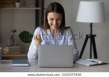 Excited office employee surprised with success, achieve, reward, looking at laptop screen, getting awesome good news, celebrating win, job result, approved loan. Worker getting job promotion Royalty-Free Stock Photo #2103373430