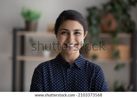 Happy young millennial Indian business woman head shot portrait. Female professional, leader, entrepreneur profile picture. Smiling confident ethnic employee looking at camera. Video call screen