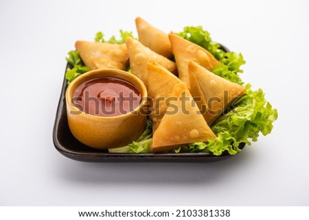 cocktail mini triangle samosa made using patti or strip, popular home made snack from India Royalty-Free Stock Photo #2103381338